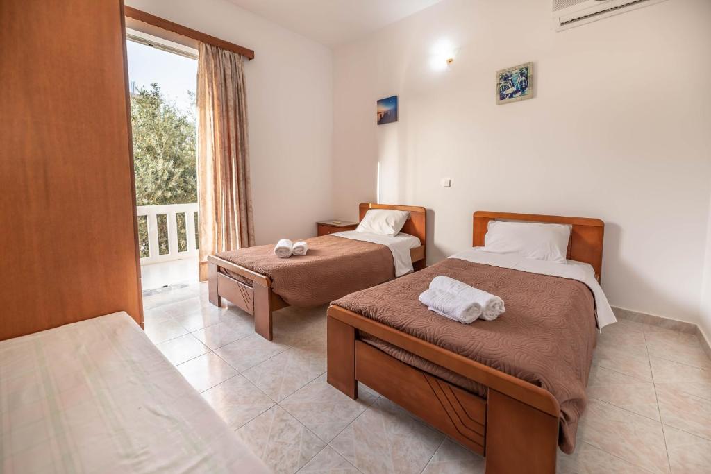 Postel nebo postele na pokoji v ubytování Hotel Ikaros