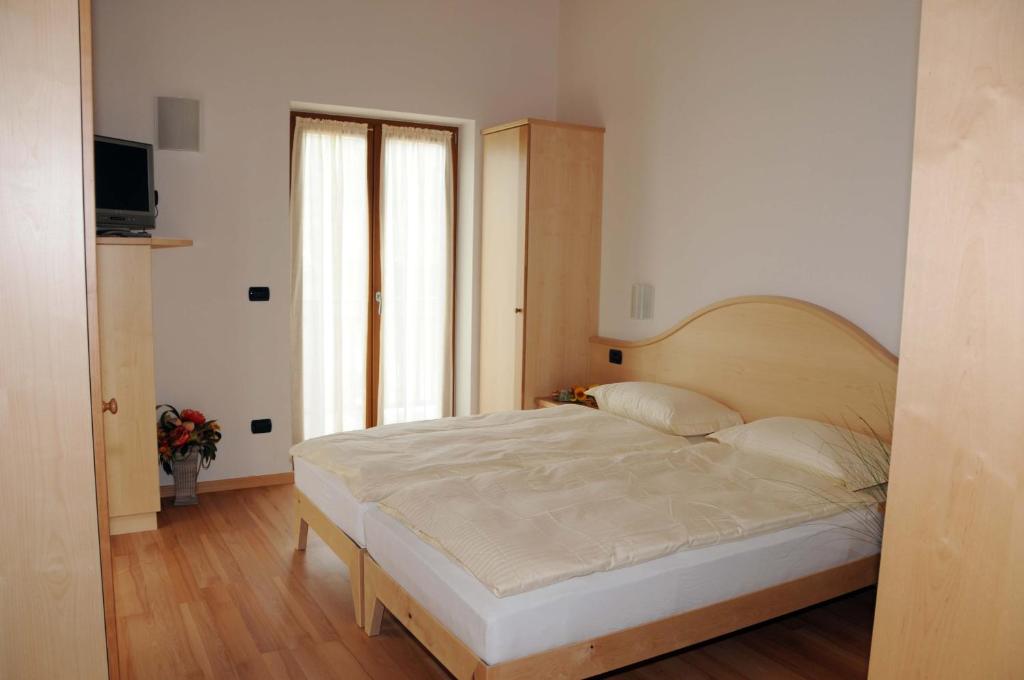 Łóżko lub łóżka w pokoju w obiekcie Agritur alla Veduta