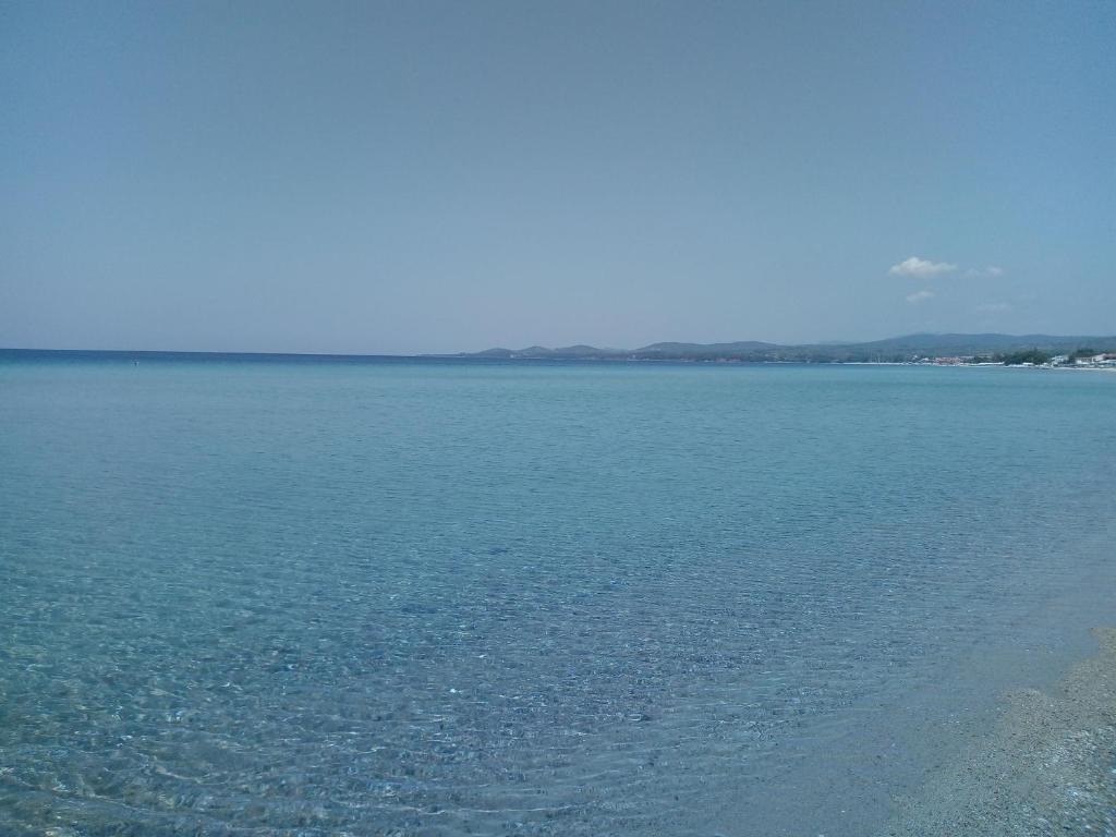 a large body of blue water with a beach at Ioannas in Nikiti