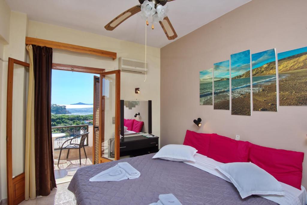 a bedroom with a bed and a view of the ocean at Gorgona Hotel in Patitiri