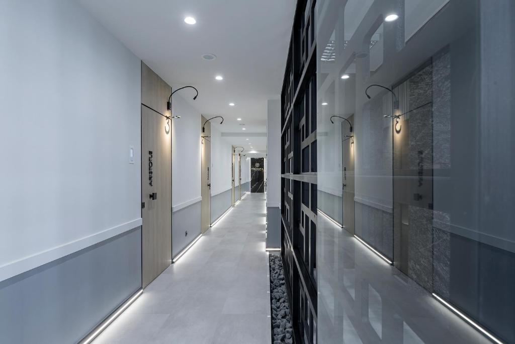 a hallway of a building with white floors and black walls at Philosofia Athens Suites in Athens