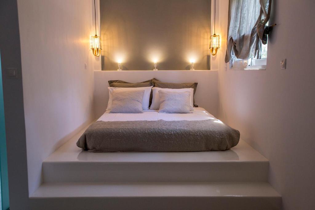 a bedroom with a bed with two pillows on it at studio lefkes kea in Vourkari