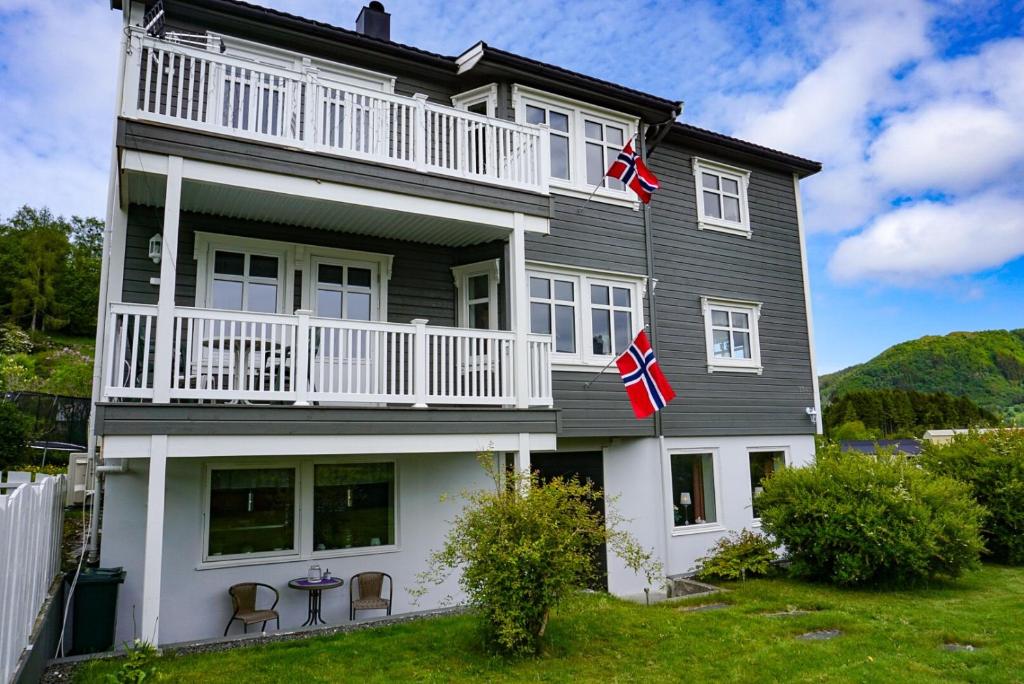 a house with two british flags in front of it at Ola Bua Near The Atlantic Road in Lyngstad