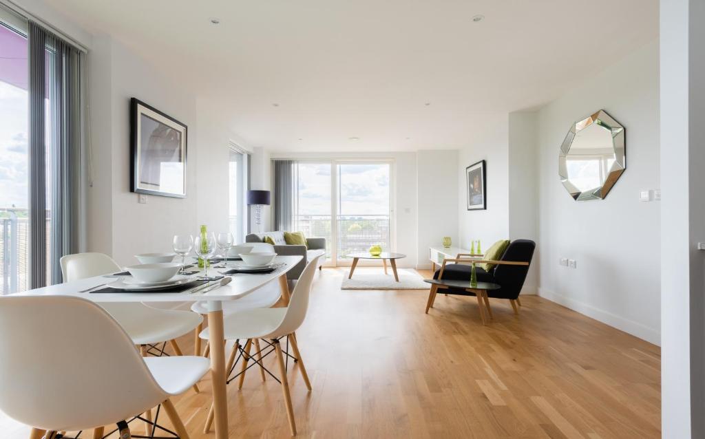 - une salle à manger et un salon avec une table et des chaises dans l'établissement 2 Bedroom 2 Bathroom Apartment with large balcony, à Londres