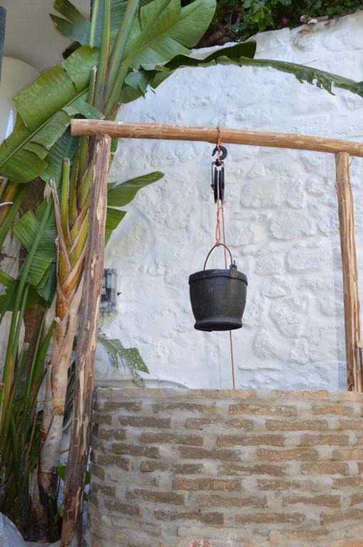 a black bucket hanging from a wall next to stairs at RIAD OASIS D'ASILAH in Asilah