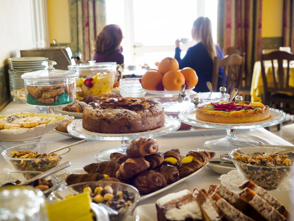 a table topped with lots of different types of food at Hotel Sirius in Taormina