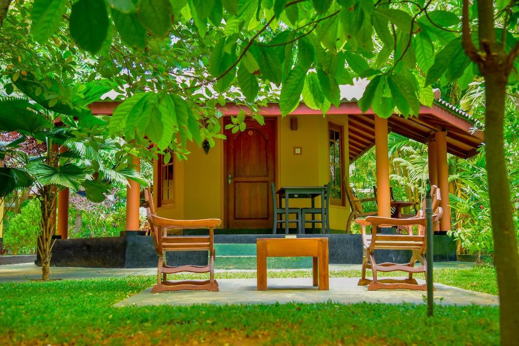 un grupo de sillas sentadas frente a una casa en Richards Cabanas, en Tissamaharama