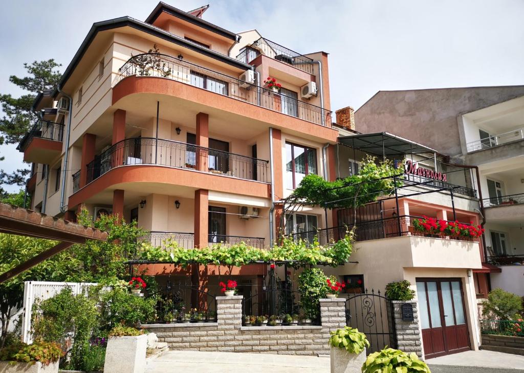 an apartment building with balconies and plants on it at Villa Magnolia in Sozopol