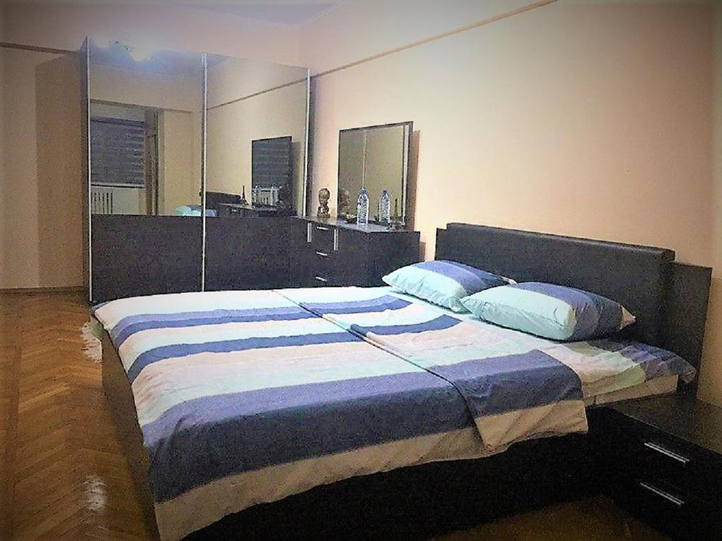 a bedroom with a large bed with two pillows at Spacious Apartment in Central Touristic Location in Tashkent