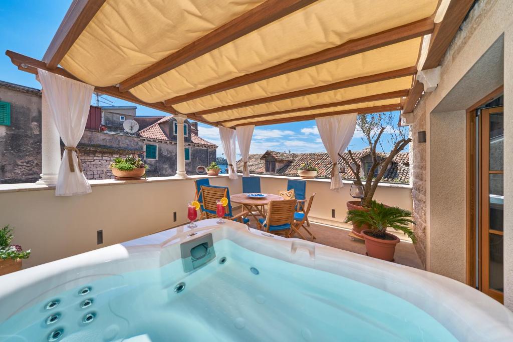 a jacuzzi tub in a room with a balcony at Villa Pergola in Šibenik