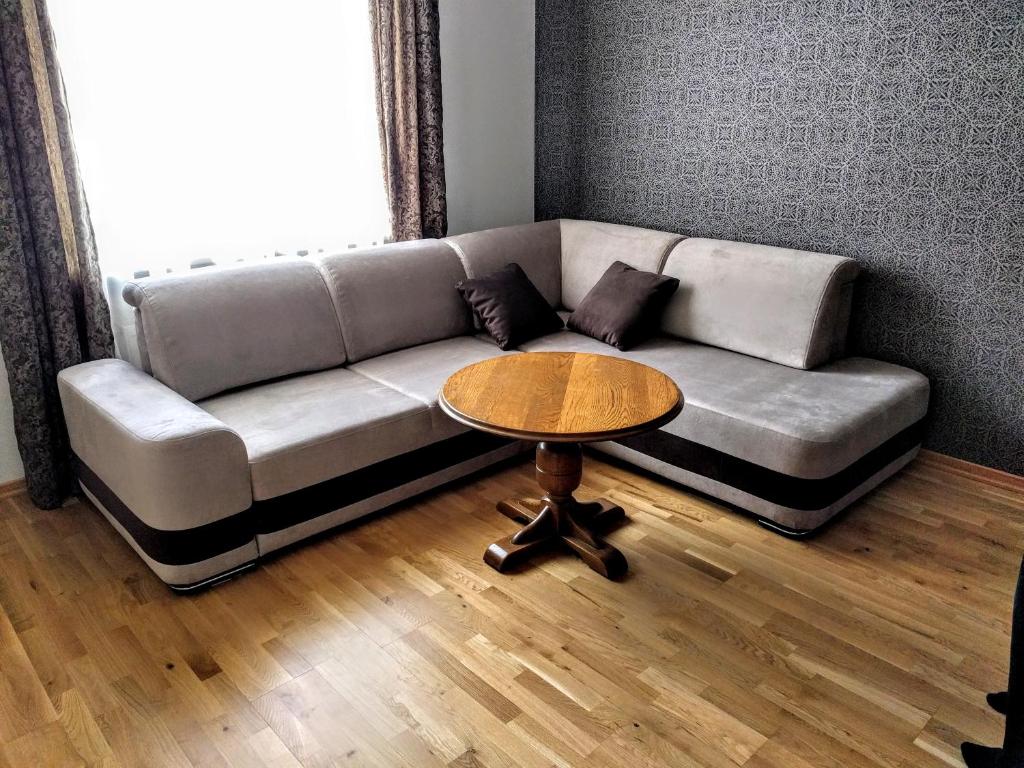 a living room with a couch and a table at Peter House in Ventspils