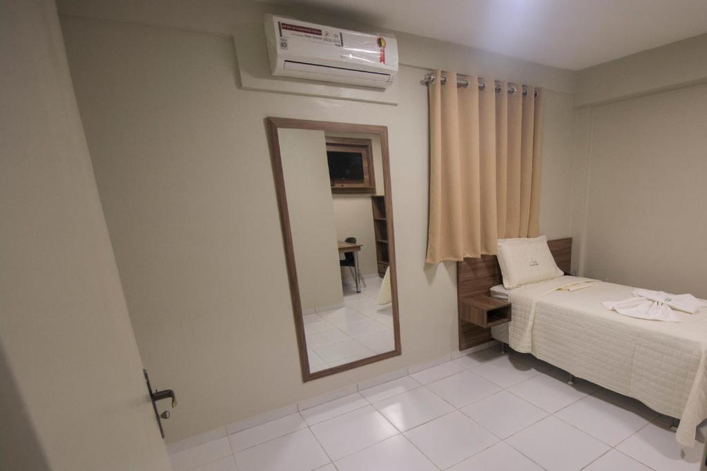 Postel nebo postele na pokoji v ubytování Hotel Encosta do Horto