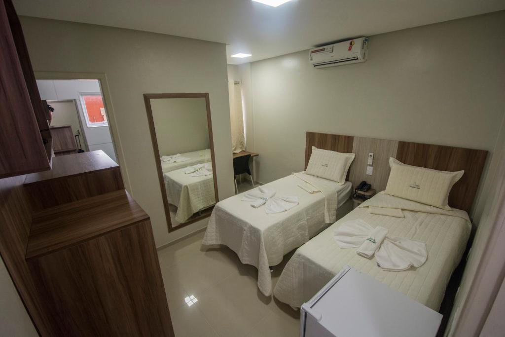Postel nebo postele na pokoji v ubytování Hotel Encosta do Horto