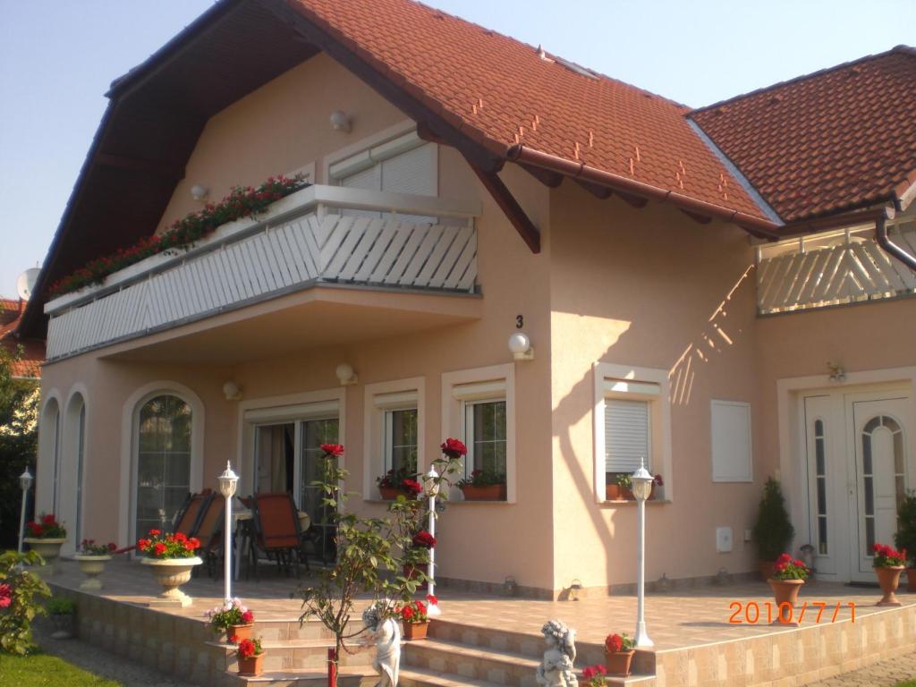 a house with a balcony on top of it at Majláth Vendégház in Bük