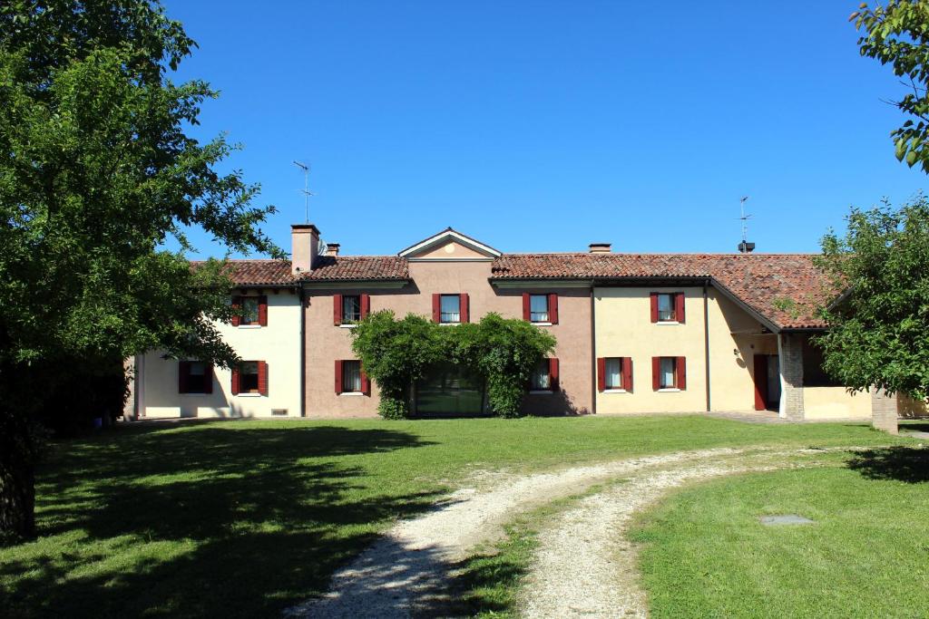 a large house with a grass yard in front of it at Tenuta Santa Lucia in Silea
