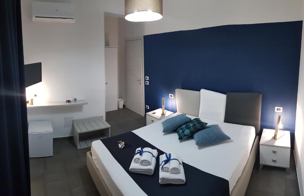 a bedroom with a large bed with two bags on it at L'Angolo Dello Zio in San Vito lo Capo