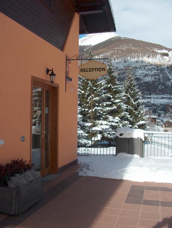 a entrance to a building with a sign that reads reception at Chalet Presanella in Temù