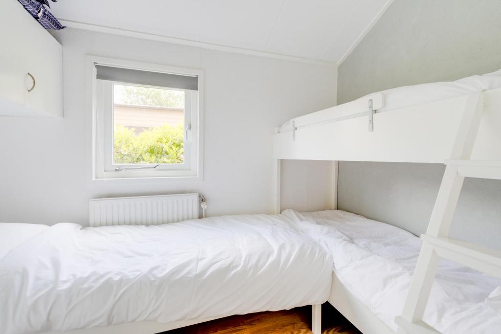 Postel nebo postele na pokoji v ubytování Chalet Descansar op de Veluwe