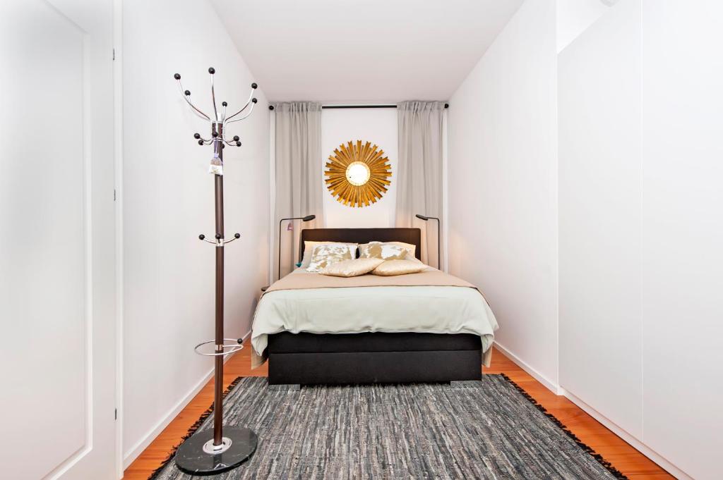 a bedroom with a bed and a mirror on the wall at Apartments Sea View - Sunrise and Maremonte in Rovinj