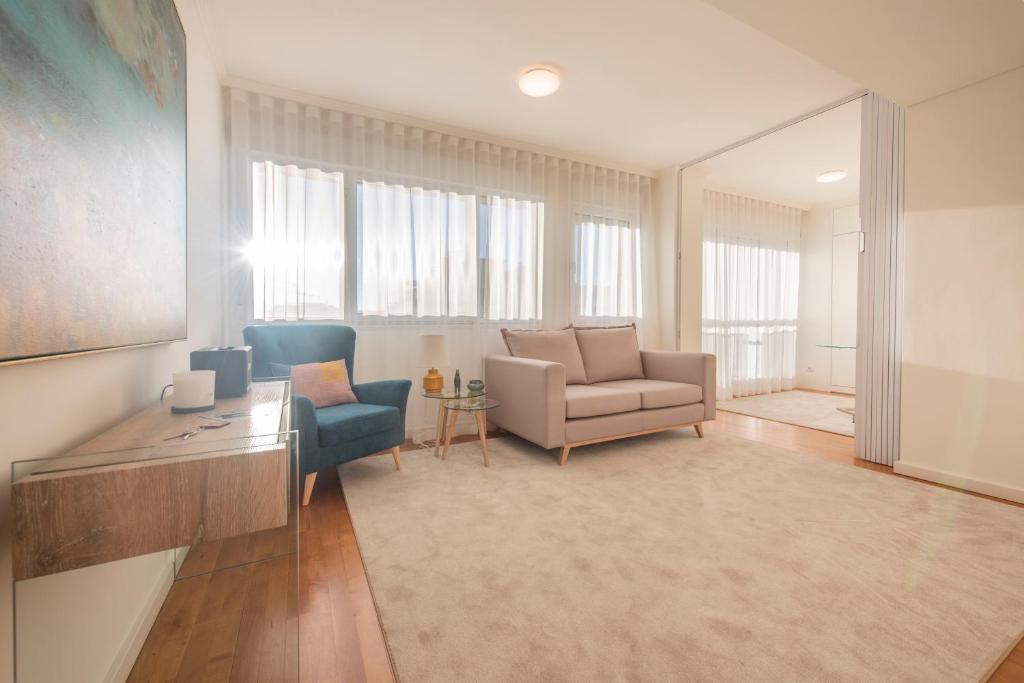 a living room with a couch and a chair at Saldanha Executive Apartment by The Portuguese Butler in Lisbon