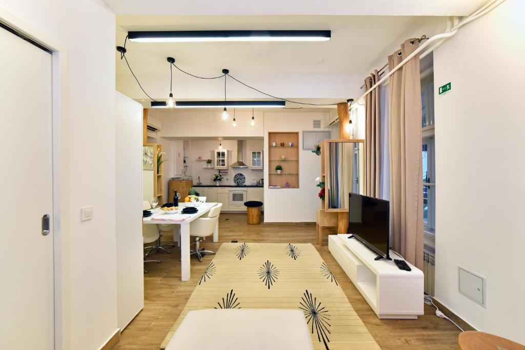 Ban Jelačić Apartment في زغرب: غرفة معيشة مع أريكة وطاولة