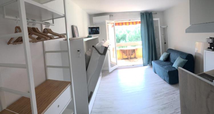 a room with a staircase and a living room at Studio rénové balcon ensoleillé et calme in La Londe-les-Maures