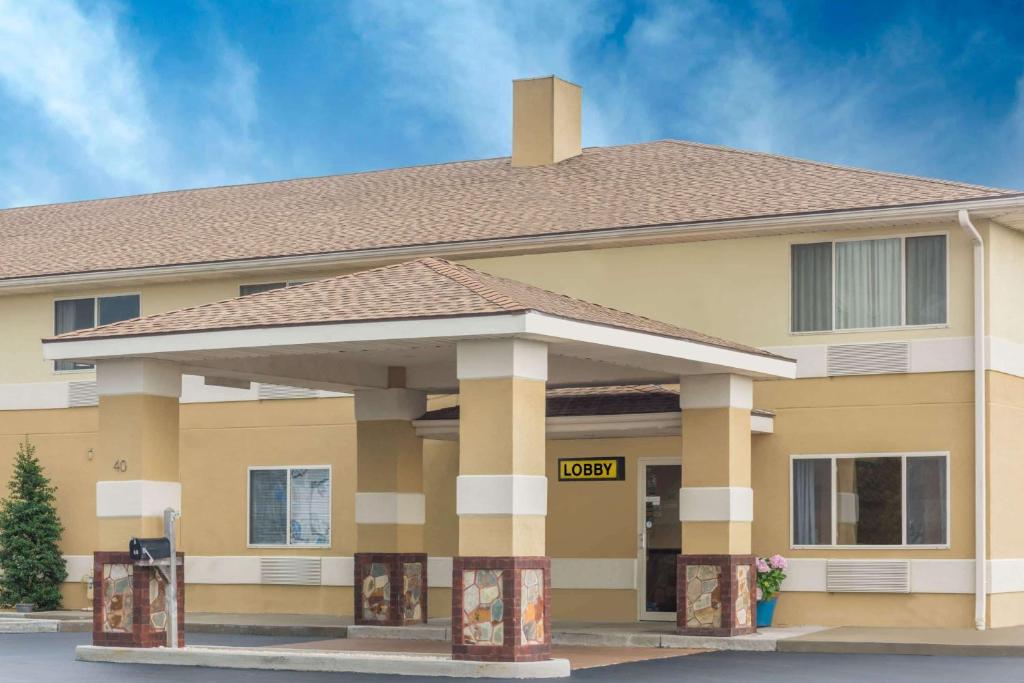 a large yellow building with a clock on it at Super 8 by Wyndham Hanover in Hanover