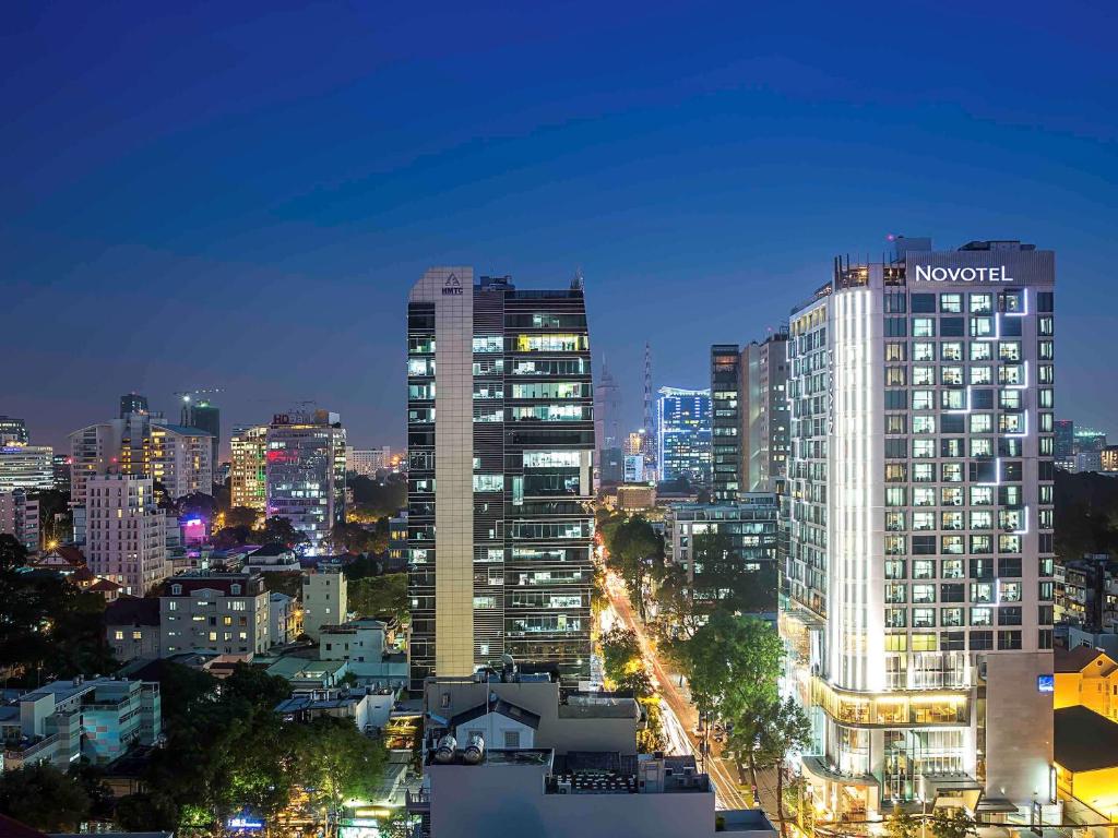 a city skyline at night with tall buildings at Novotel Saigon Centre in Ho Chi Minh City