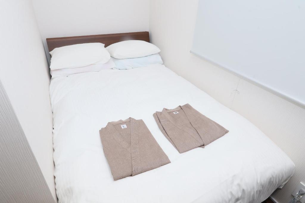 Postel nebo postele na pokoji v ubytování Business Capsule Hotel Lightning Hotel Asakusa
