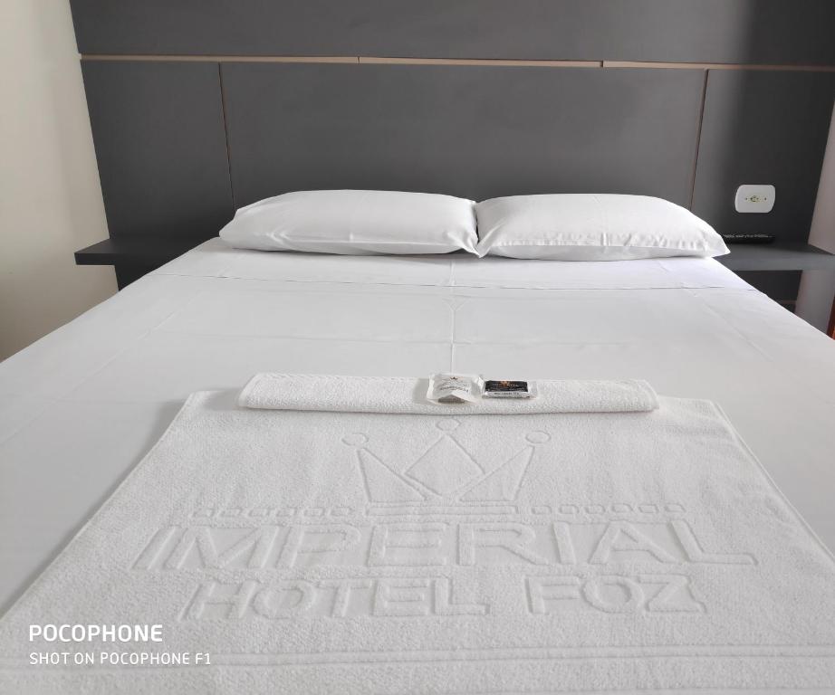 Un primer plano de una cama con una manta. en Imperial Hotel, en Foz do Iguaçu