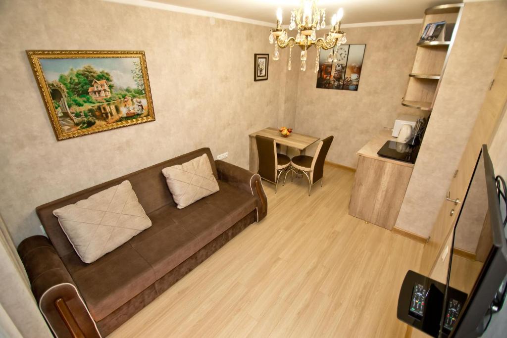 a living room with a couch and a table at Orbi bakuriani aparthotel 905 in Bakuriani