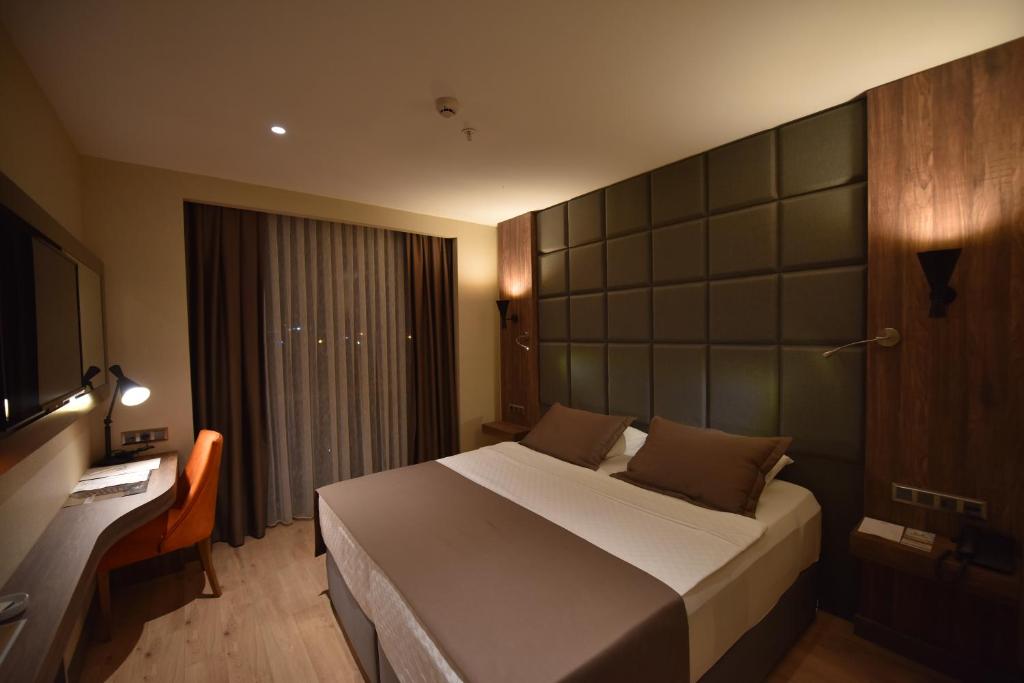 Postel nebo postele na pokoji v ubytování NEW KARAMAN HOTEL