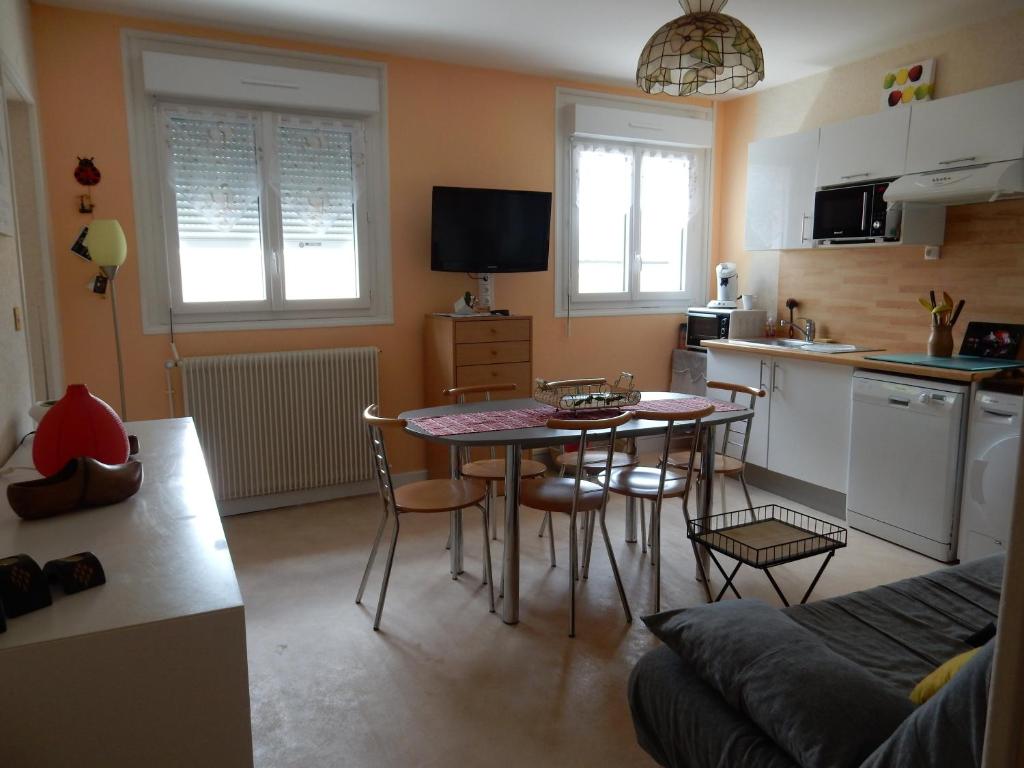 a kitchen with a table and chairs in a room at LES EGLETYERES in Le Mont-Dore