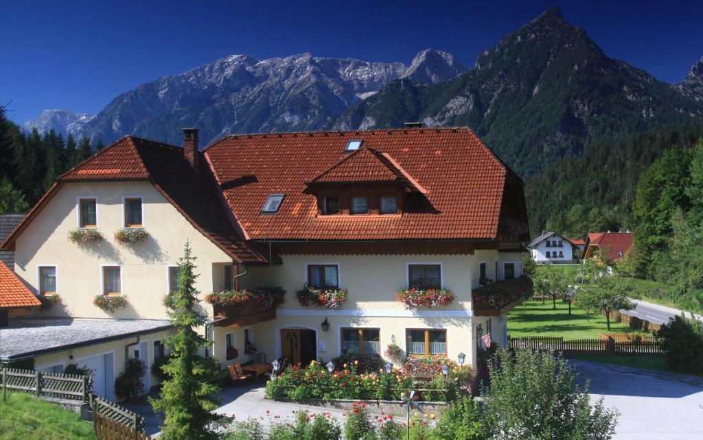 a large white house with a red roof at Pension Pichler in Hinterstoder