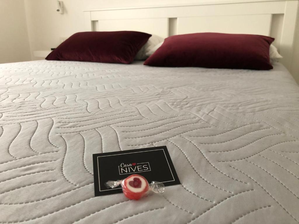 a mattress with a book on it on a bed at Casa Nives in Sottomarina