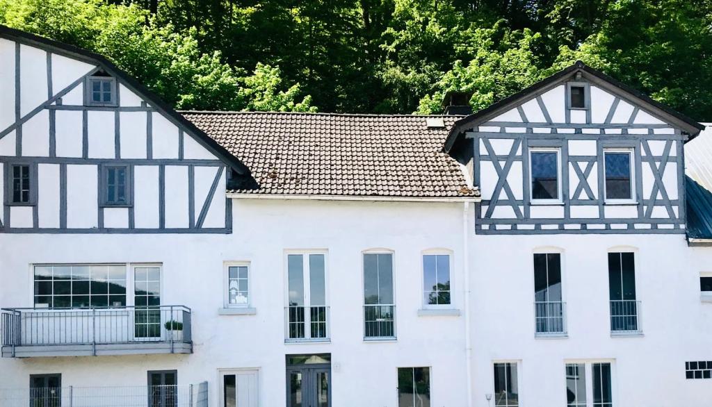 an old house with black and white architecture at Talmühle Hirtscheid in Hirtscheid