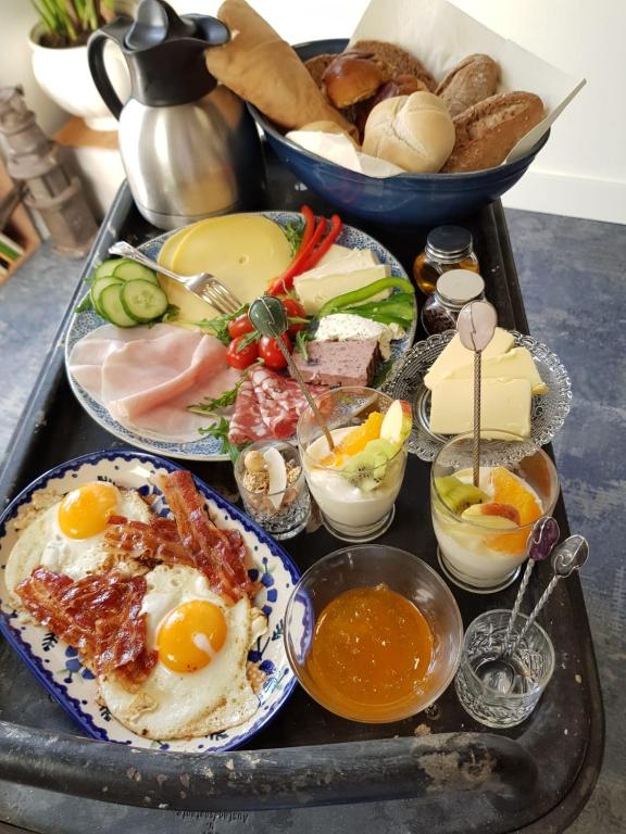 a tray of food with eggs and other foods on it at B&B The Project in Heerlen