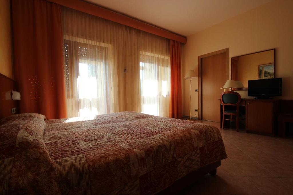 Postel nebo postele na pokoji v ubytování Hotel Oasi Dei Discepoli