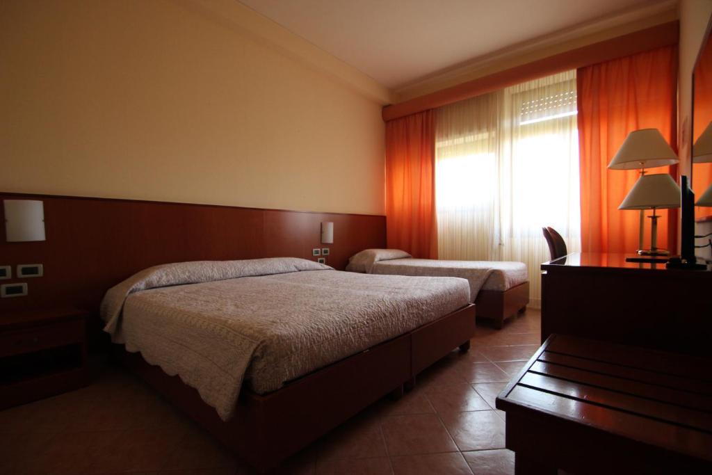 Postel nebo postele na pokoji v ubytování Hotel Oasi Dei Discepoli