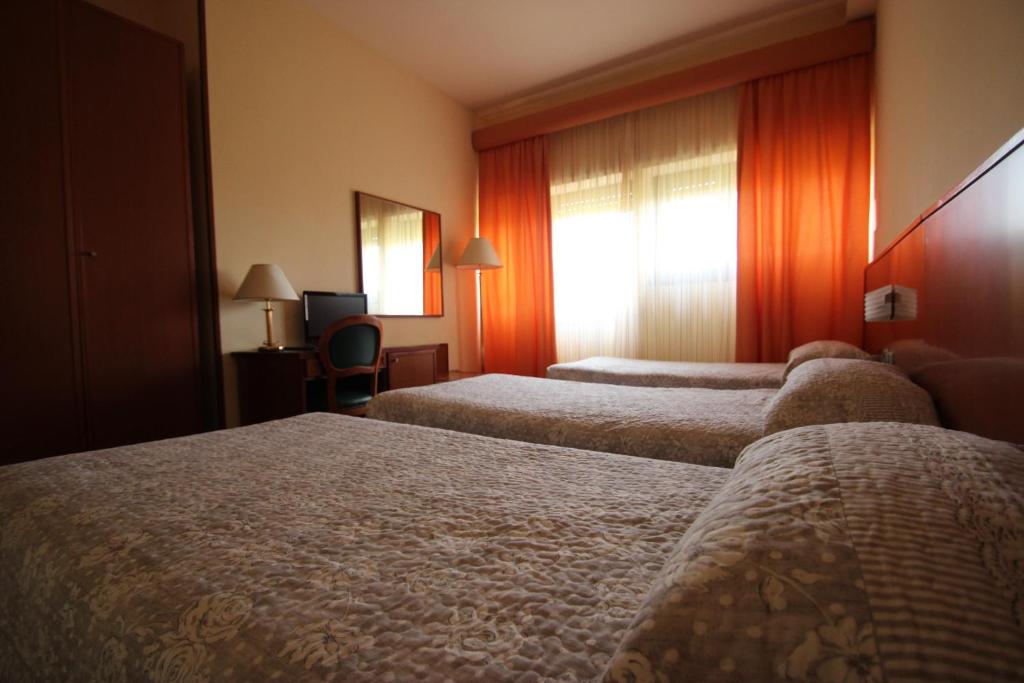 Postel nebo postele na pokoji v ubytování Hotel Oasi Dei Discepoli