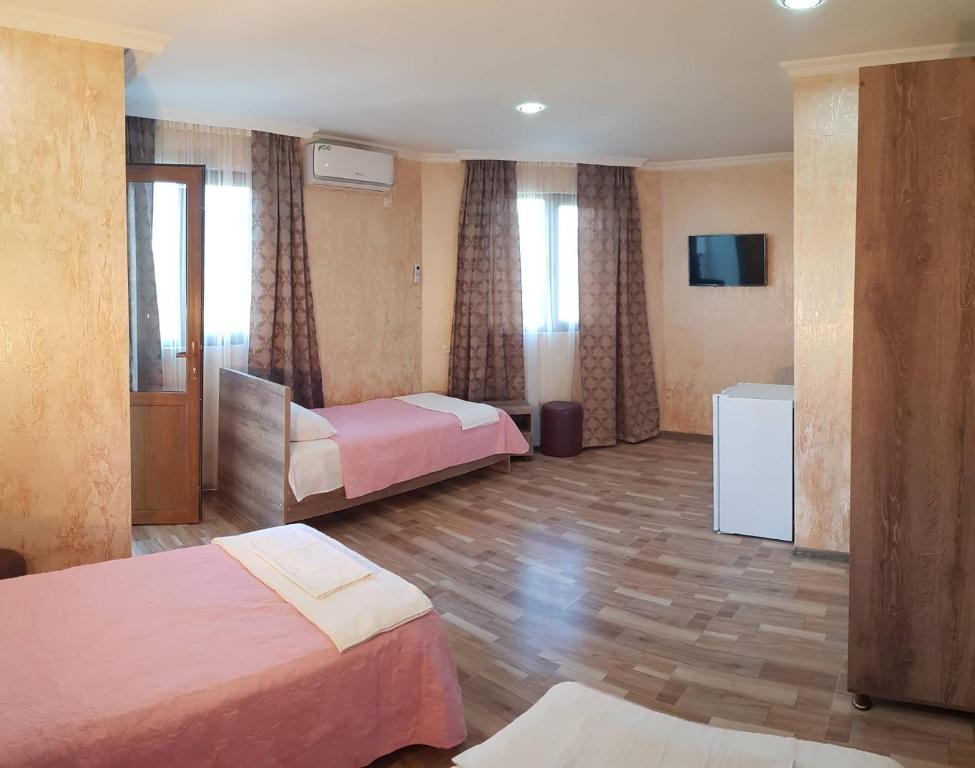 Postel nebo postele na pokoji v ubytování Guest House MARINA