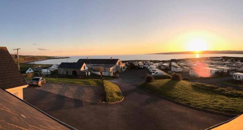 a view of a town with the sunset in the background at The View in Lahinch