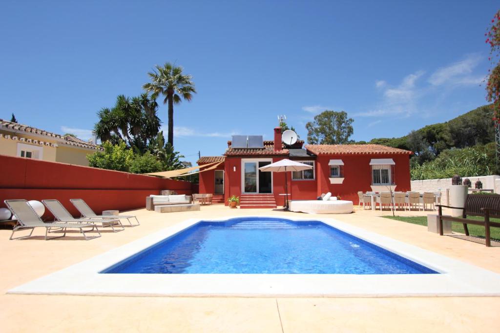 a swimming pool in front of a house at villa in puerto banus in Marbella