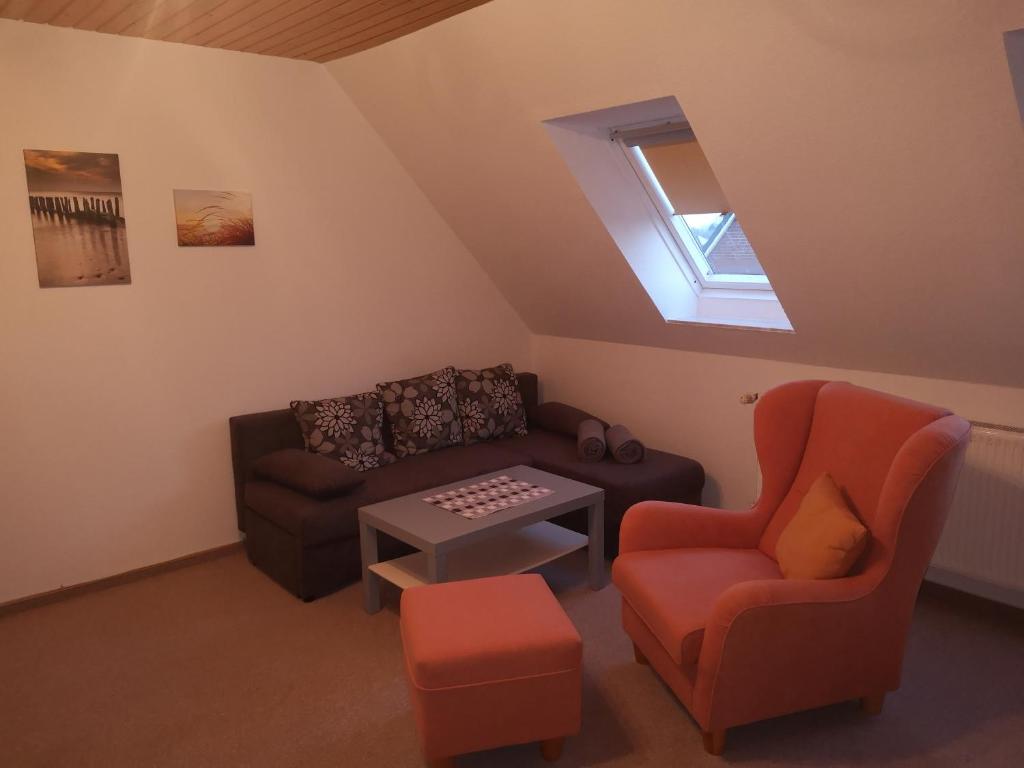 a living room with a couch and a chair at Ferienwohnung Almdorf in Almdorf