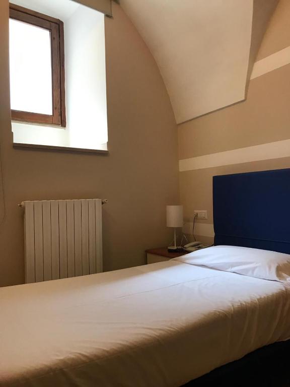 Postel nebo postele na pokoji v ubytování Albergo Ristorante del Cacciatore