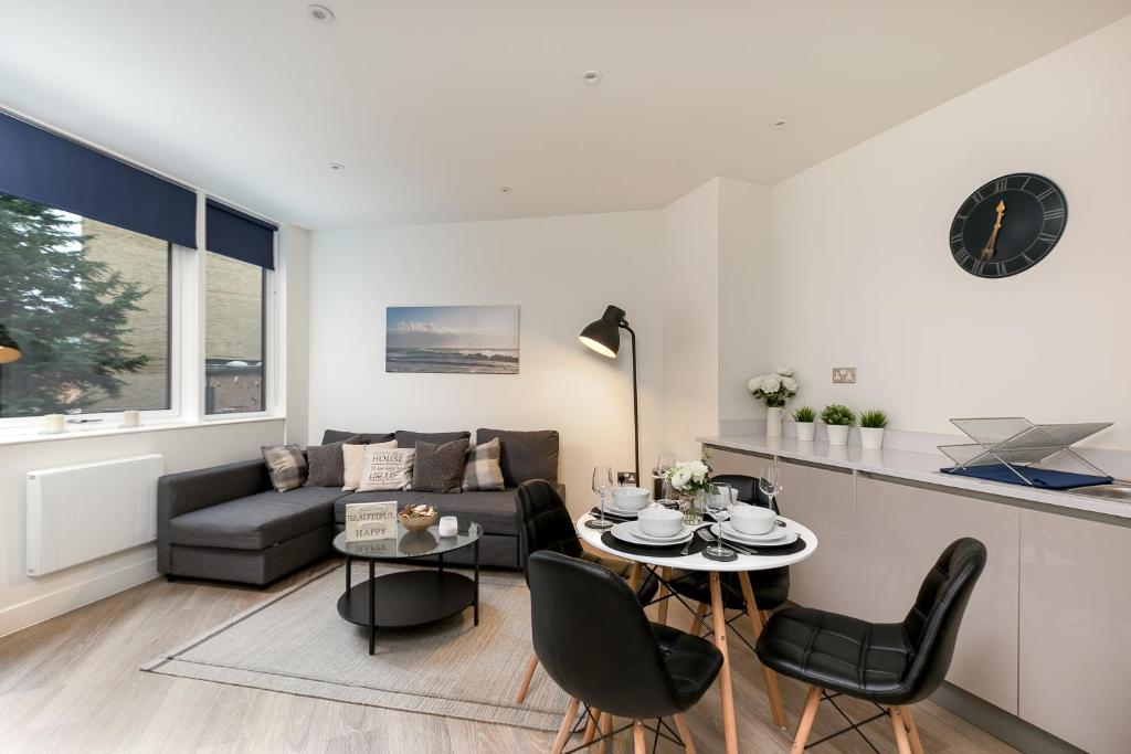 a living room with a couch and a table at Kings Reach Reading in Reading