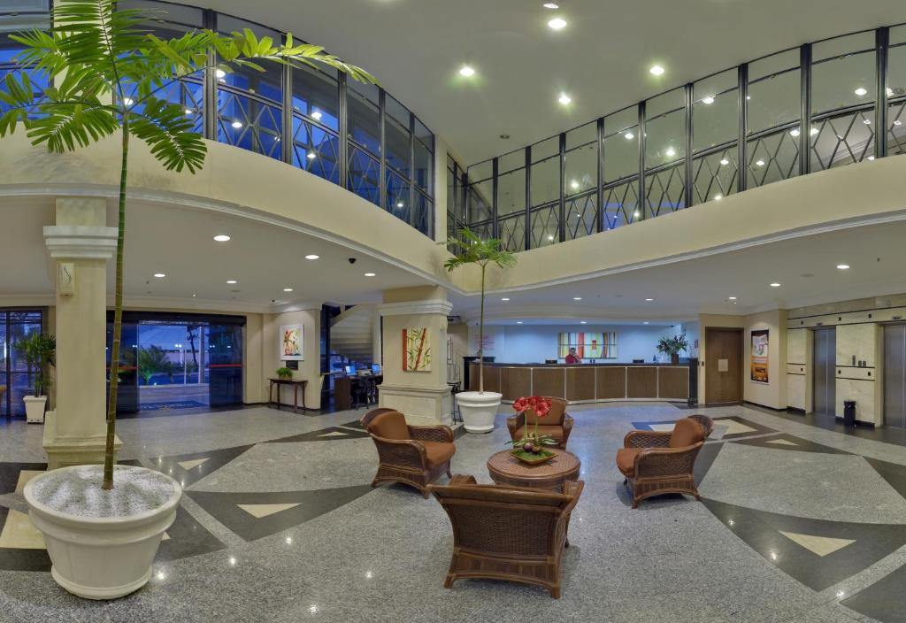 a lobby with a palm tree in a building at Tulip Inn Fortaleza in Fortaleza