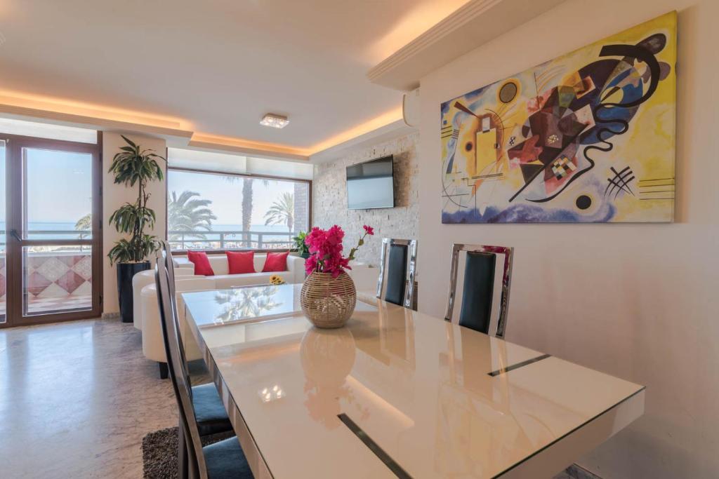 a dining room with a table and a painting on the wall at New Luxury Premium in Málaga
