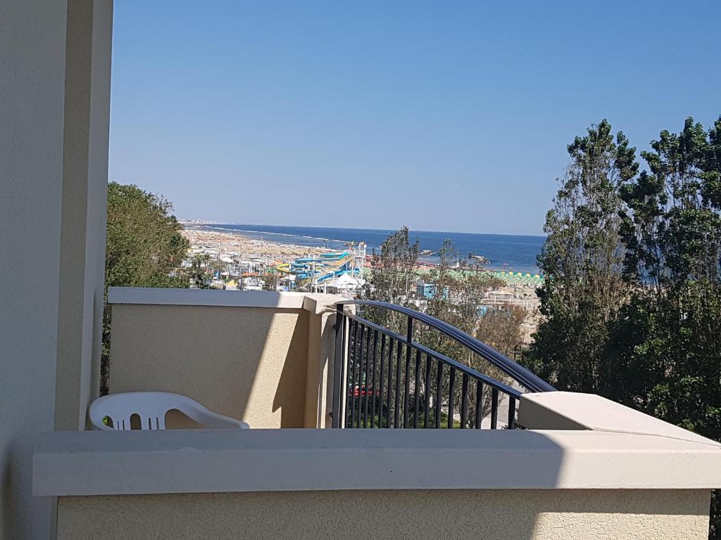 a balcony of a house with a view of the ocean at Hotel De La Plage in Rimini