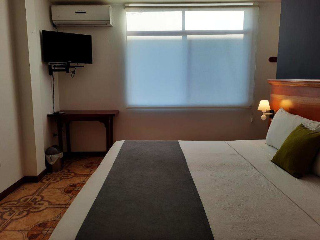 Postel nebo postele na pokoji v ubytování Casa D´Cristhi